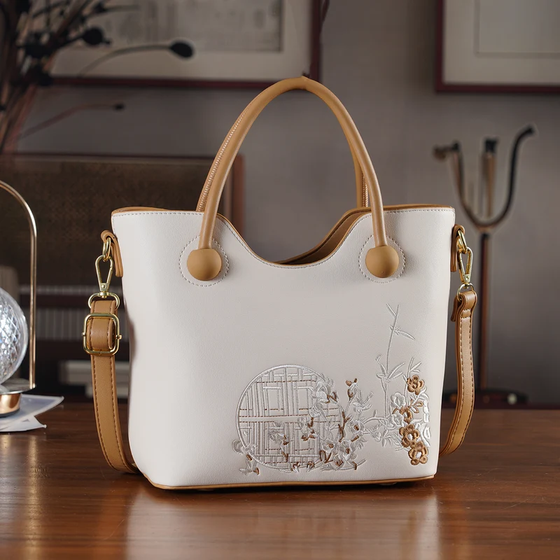 Kunstleder-Handtasche mit Tragegriffen und Umhängeriemen, florales Detail, Reißverschlussfächer, 30x22x11 cm, Gelb/Creme
