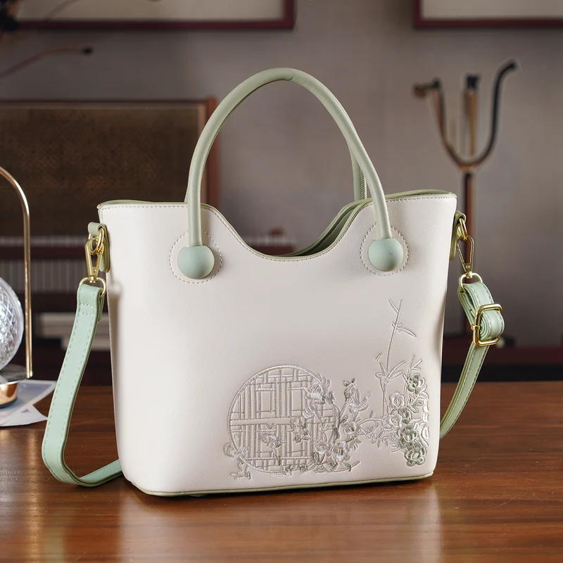 Kunstleder-Handtasche mit Tragegriffen und Umhängeriemen, florales Detail, Reißverschlussfächer, 30x22x11 cm, Gelb/Creme